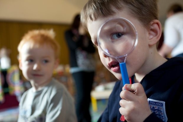 Boy looking through magnifying glass