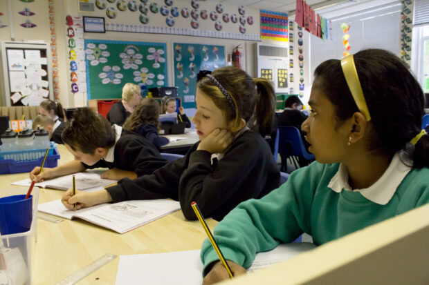 Children writing in notebooks