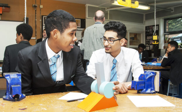 Two pupils in a classroom doing design and technology.