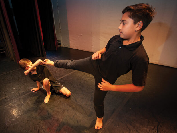 Two boys dancing in a studio.