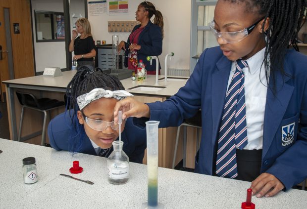 Pupils in a chemistry lesson doing an experiment. 