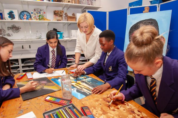 Children with their teacher drawind during an art class