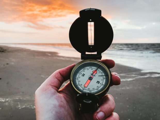 picture of a hand holding a compass