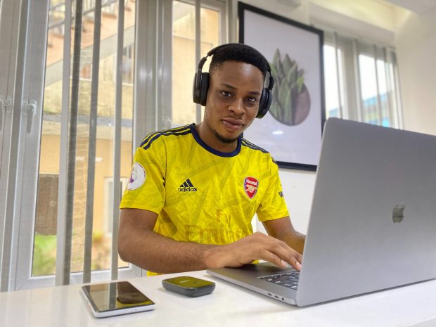 Teenage boy sitting working at a laptop
