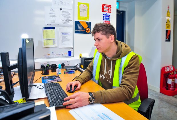 Construction student sat working at a computer