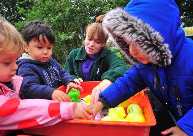 early years teacher playing with children