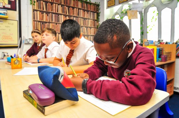 Primary-aged boys working at their desks