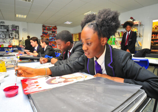 Pupils painting in a school art lesson.