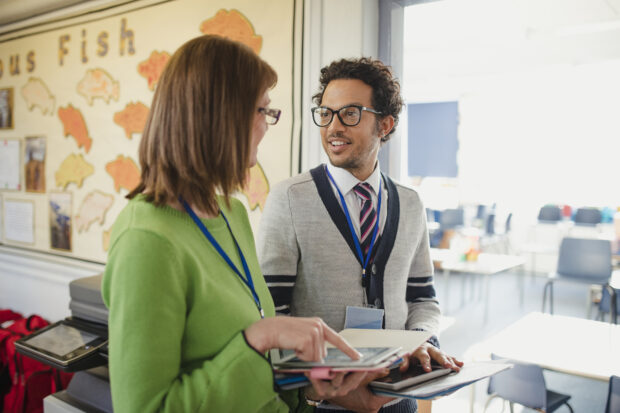 Two teachers chatting in a classroom