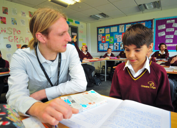 Teacher and child reading a book