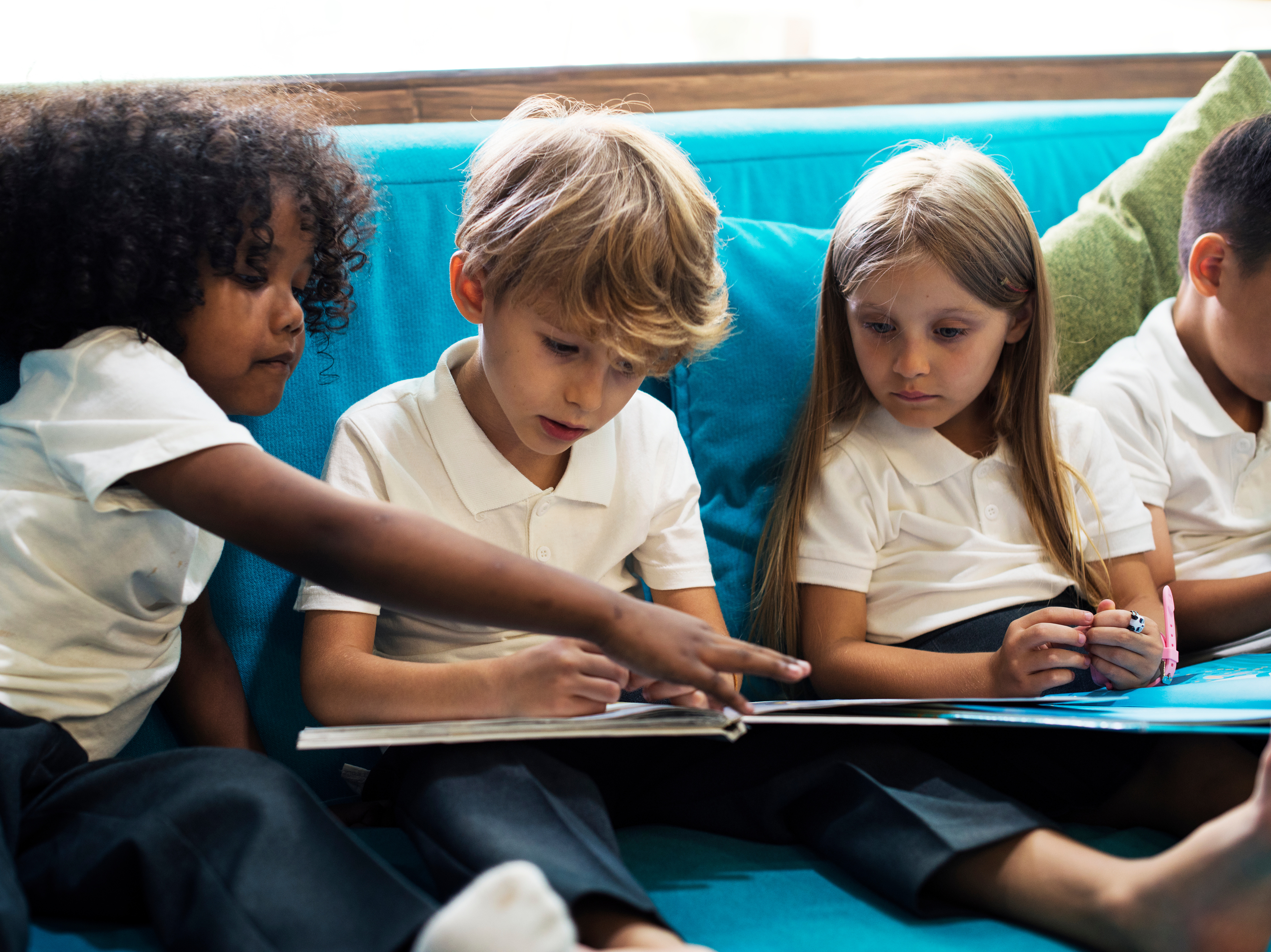 A group of young children reading together